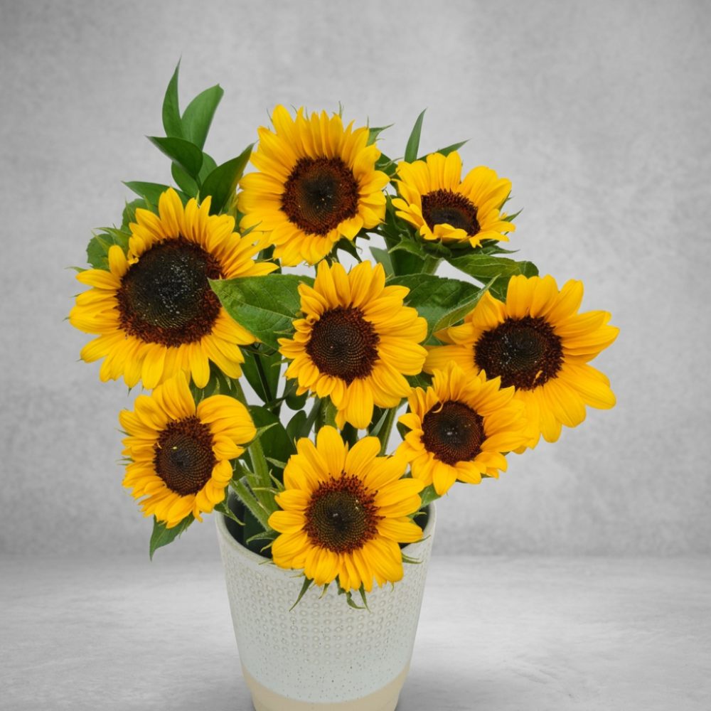 Vibrant yellow seasonal sunflower bouquet wrapped in eco-friendly brown kraft paper on a rustic wooden table.